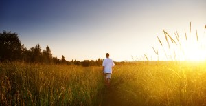 young man walking on field